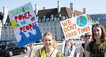 Climate protestors holding up banners