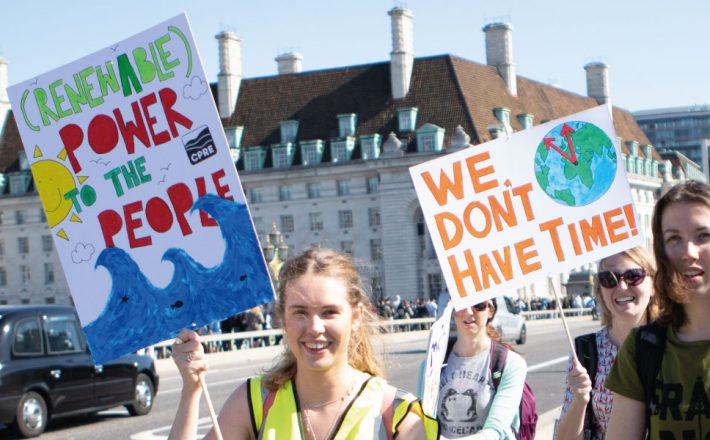 Climate protestors holding up banners